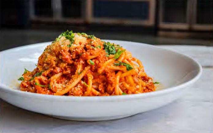 A bowl of pasta with meat and cheese.